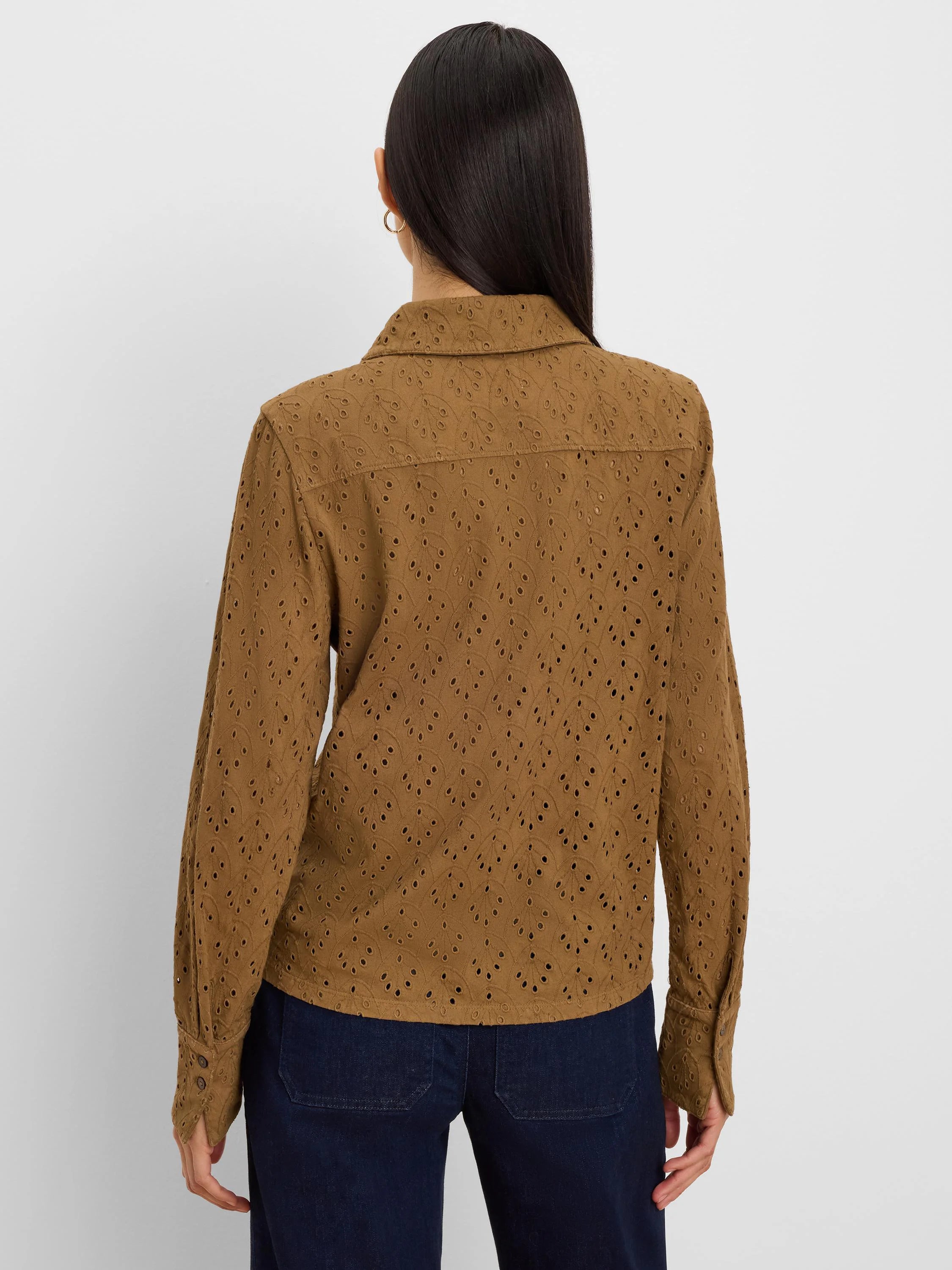 Brown long-sleeved pop-on top with a collar, featuring an all-over intricate eyelet pattern.