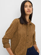 Warm brown button-front knit top with long cuffed sleeves and an all-over leaf eyelet pattern.
