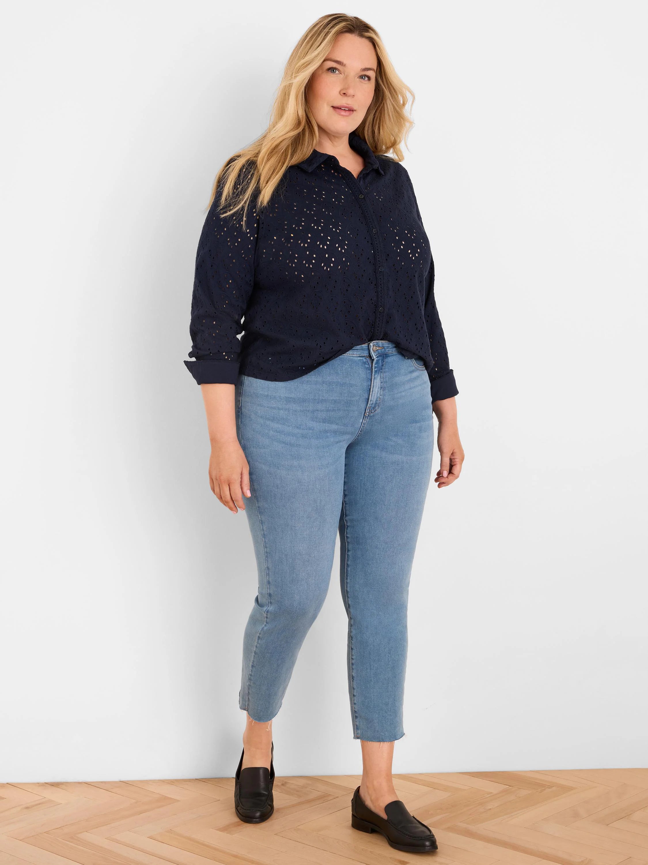 Navy knit eyelet top with a collar, button-front, and 3/4 rolled sleeves.