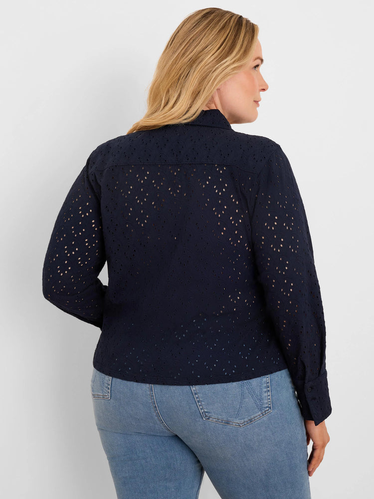Navy blue eyelet top on model, viewed from back. Features long sleeves, a collar, and small scalloped holes throughout.