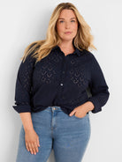 Navy collared button-front top with all-over eyelet perforations and rolled 3/4 sleeves.
