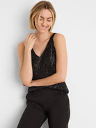 Black sequin tank with V-neck, sleeveless. Features a shimmering texture.