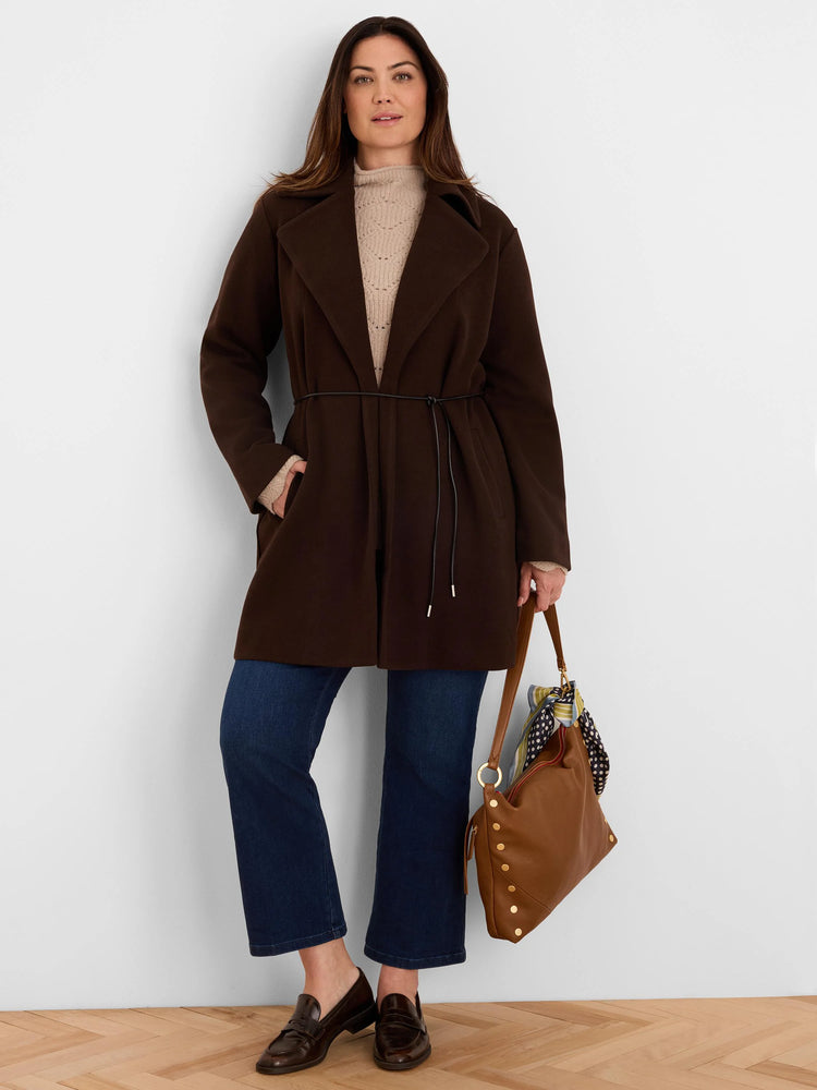 Dark brown knit twill wrap jacket with wide lapels, cinched with a thin dark belt, and reaching mid-thigh.