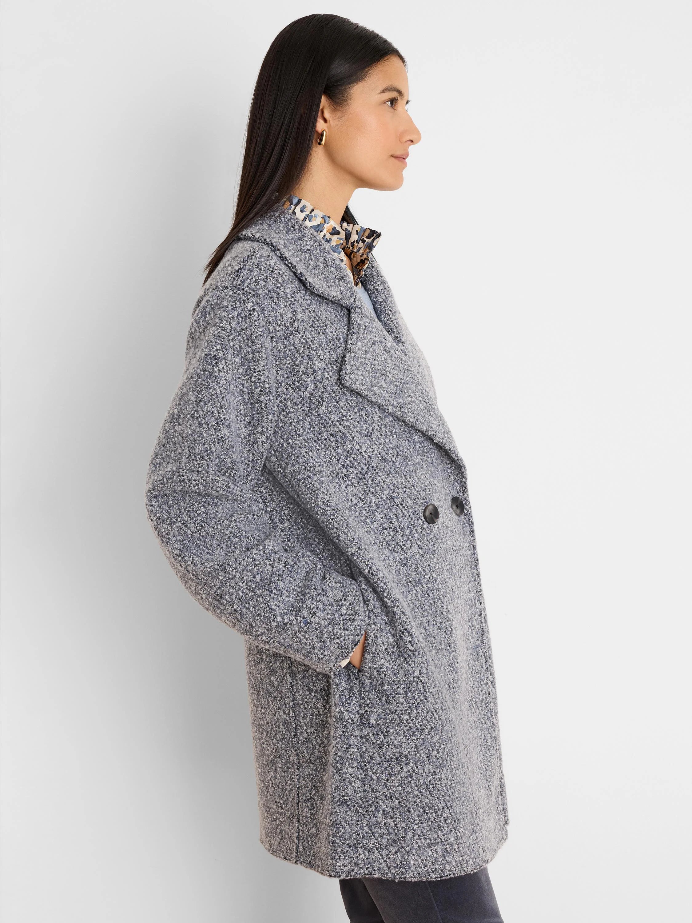 Heather grey boucle knit jacket with white/blue flecks, wide lapels, double-breasted front, and side pockets.