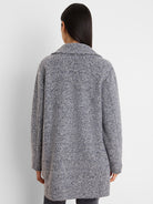 Mixed grey, black, and blue boucle knit jacket, textured, with a collar, viewed from behind.