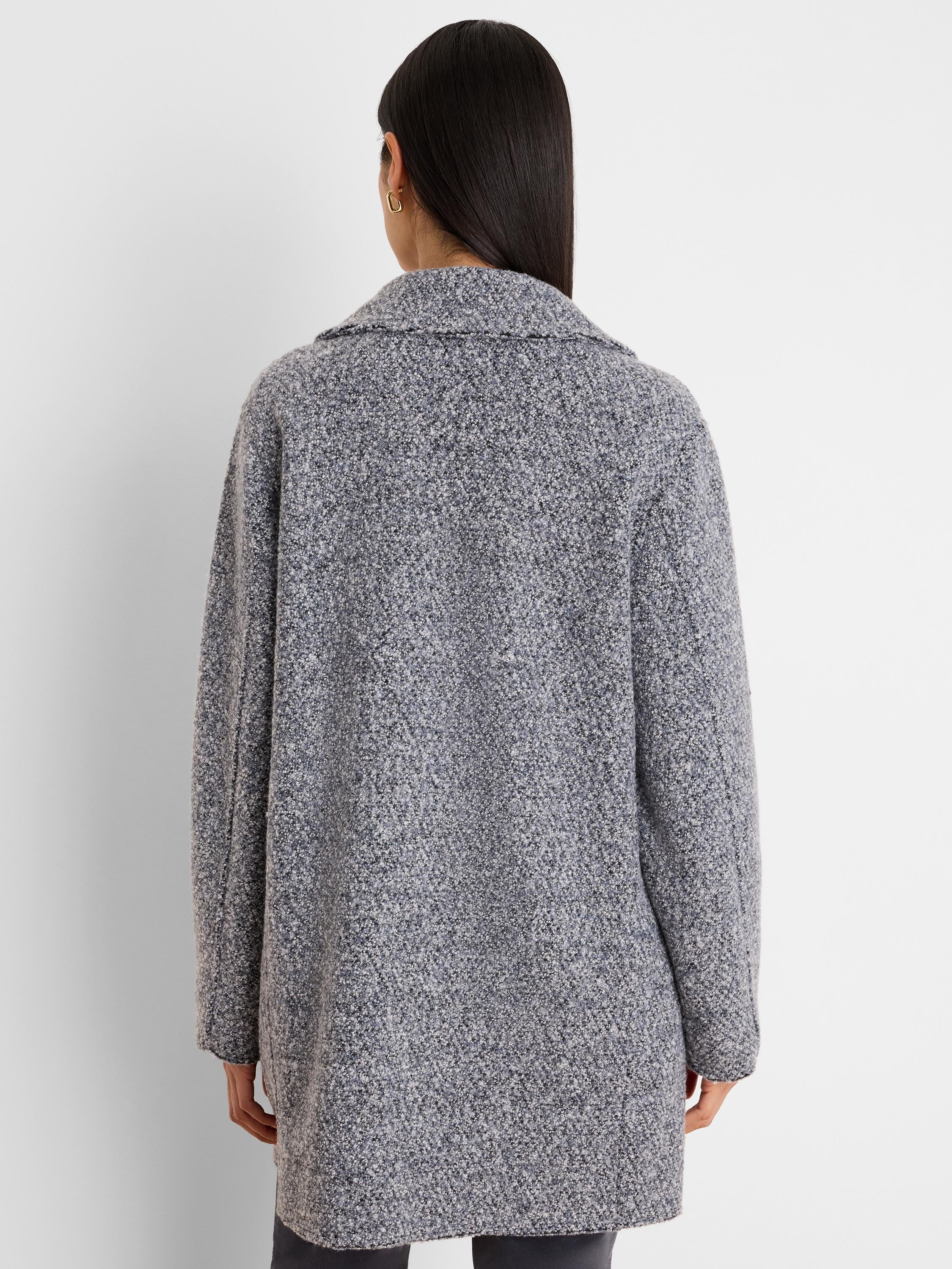 Mixed grey, black, and blue boucle knit jacket, textured, with a collar, viewed from behind.