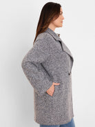 Flecked grey boucle knit jacket with wide lapels, front buttons, and side pockets.