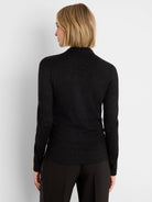 Black long-sleeve top with subtle sparkle, mock neck, and ruching along the side, viewed from the back.