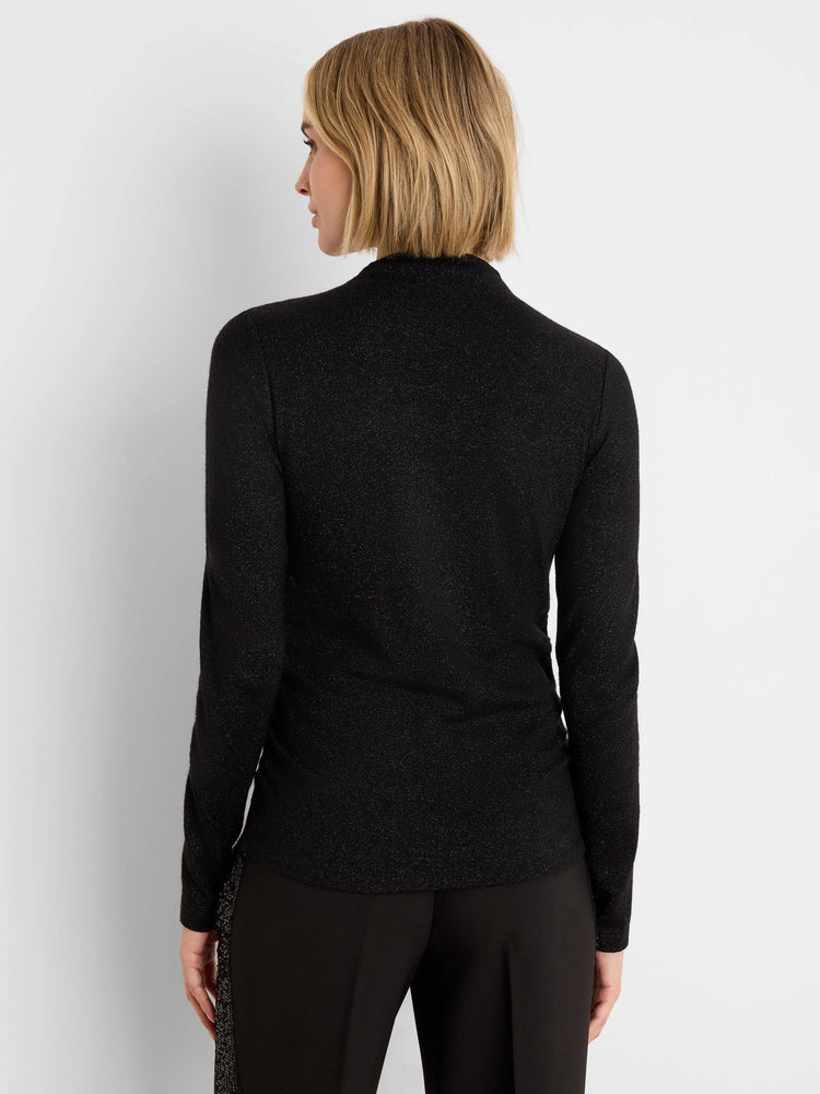 Black long-sleeve top with subtle sparkle, mock neck, and ruching along the side, viewed from the back.