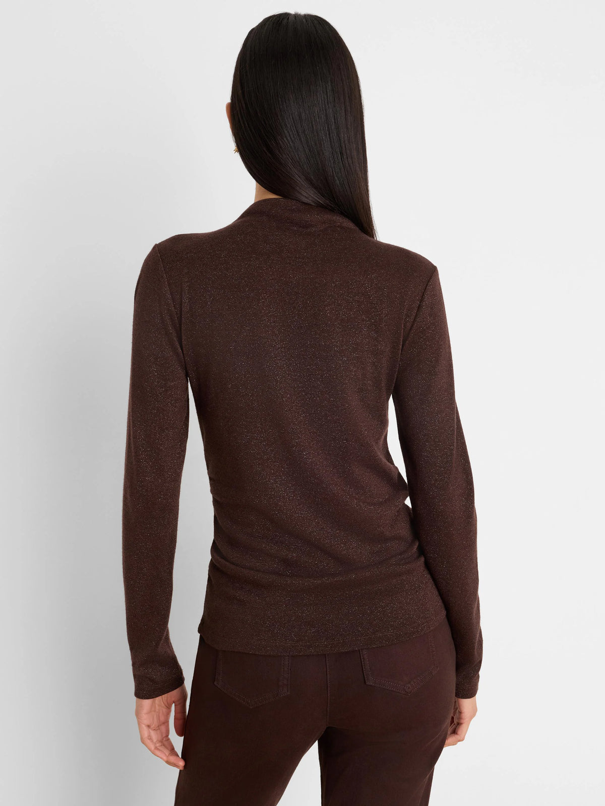 Dark brown shimmery long-sleeve top with a mock neck, fitted, shown from the back on a model.