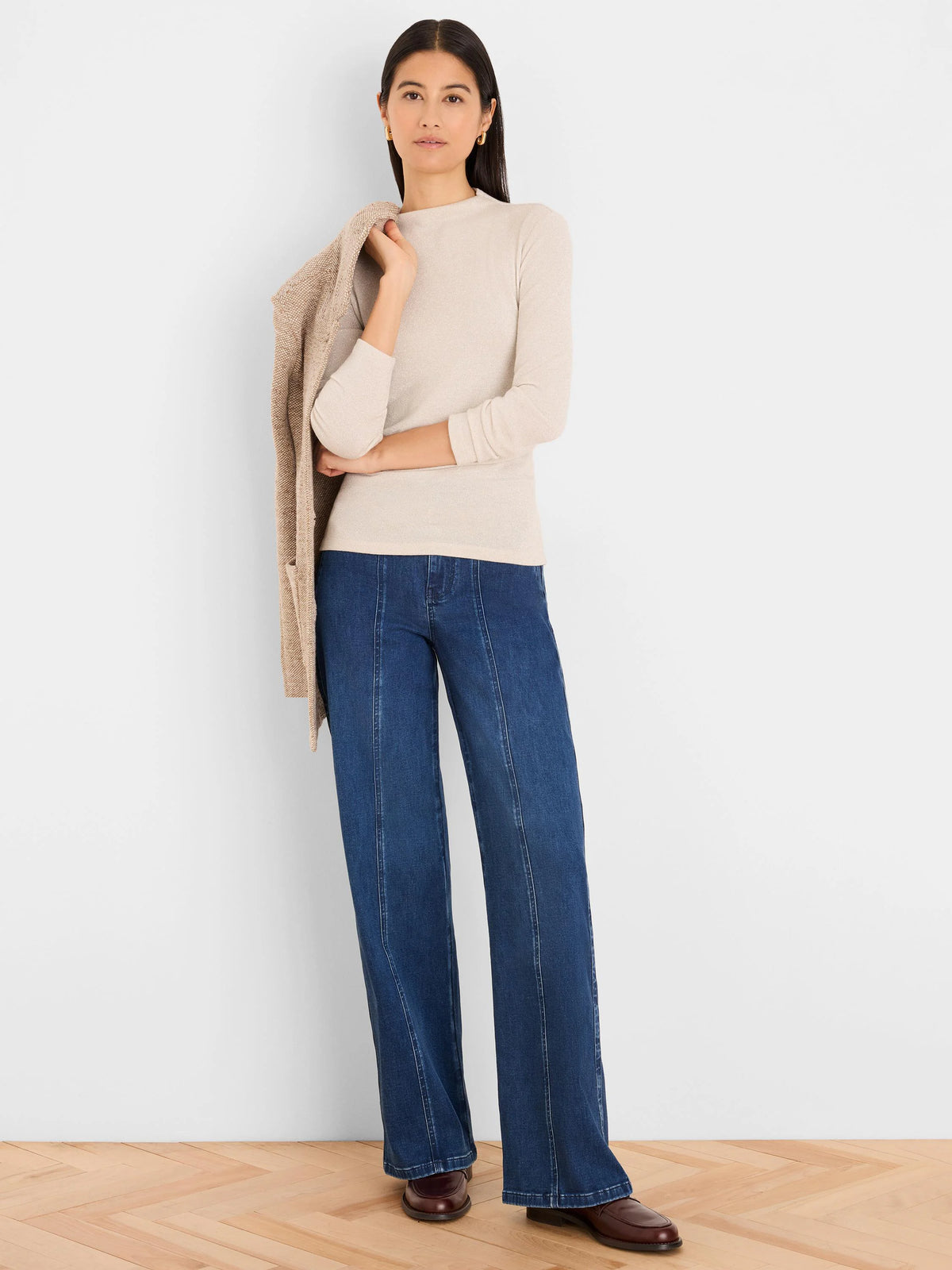 Shimmery light beige long-sleeve mock-neck top.