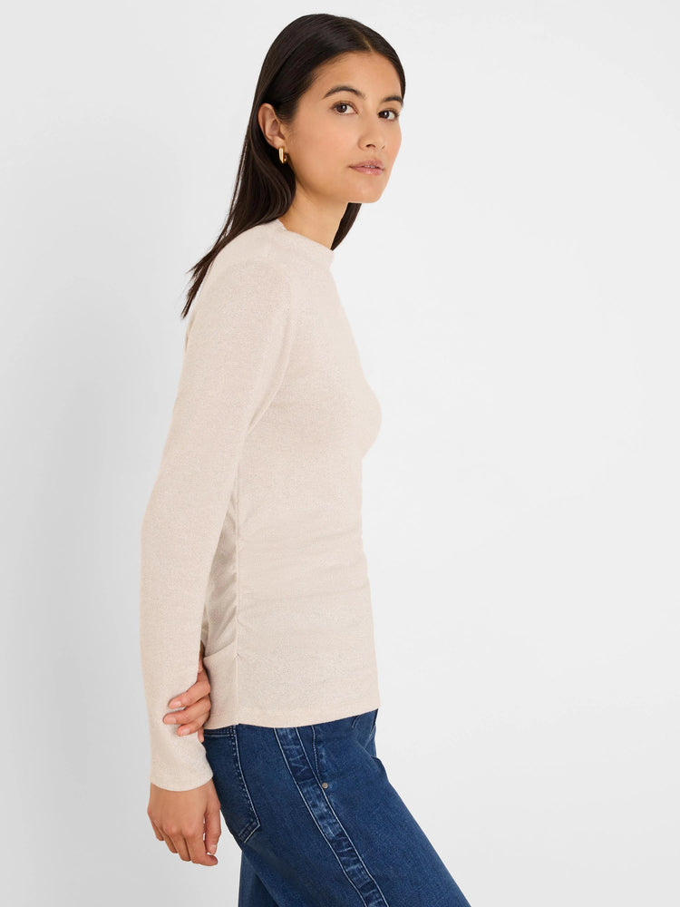 Shimmery beige long-sleeve top with side ruching and a high round neck, worn by a model.