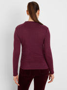 Burgundy long-sleeve top with subtle sparkle and horizontal ruching, viewed from the back.