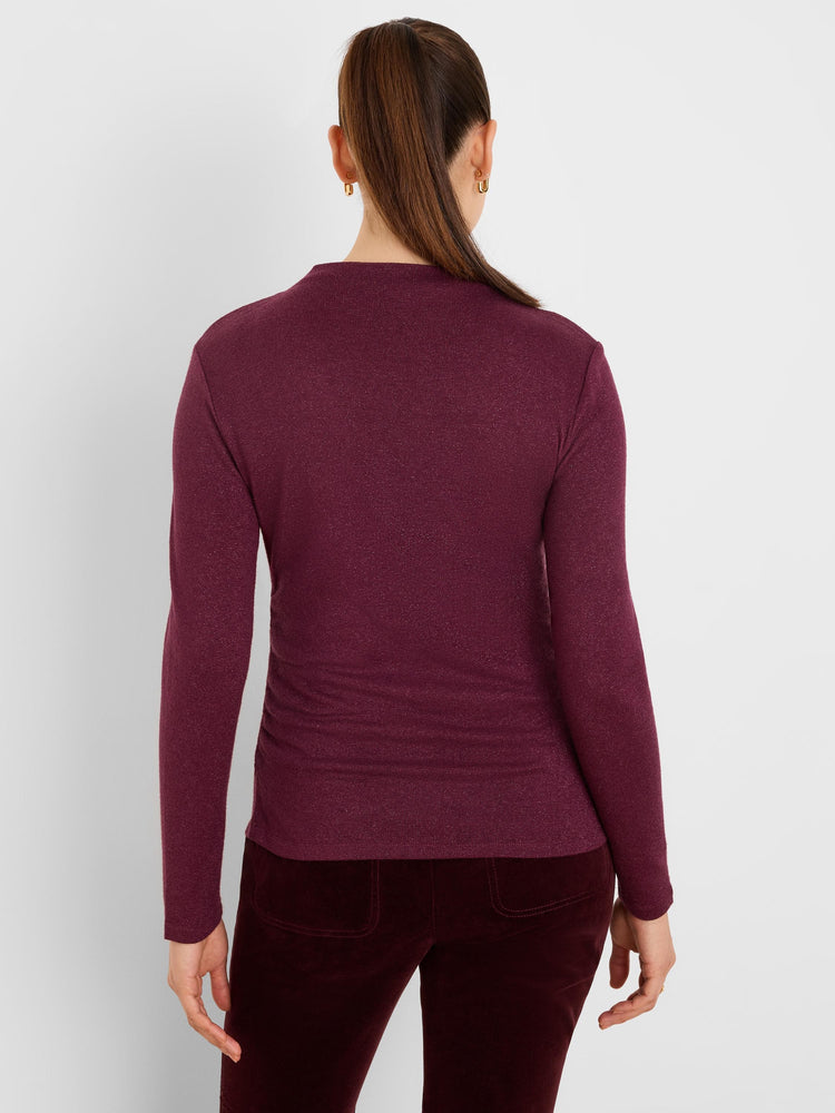 Burgundy long-sleeve top with subtle sparkle and horizontal ruching, viewed from the back.