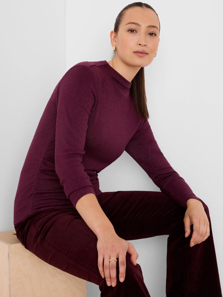 Deep plum, long-sleeve, high-neck top with subtle sparkle and ruched side detail.