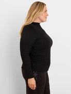 Black shimmering high-neck top with long sleeves and side ruching.