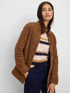 Camel brown quilted jacket with a diamond pattern, button front, and stand-up collar.