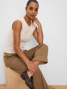 Light beige ribbed knit tank top with a round neck and cap sleeves.
