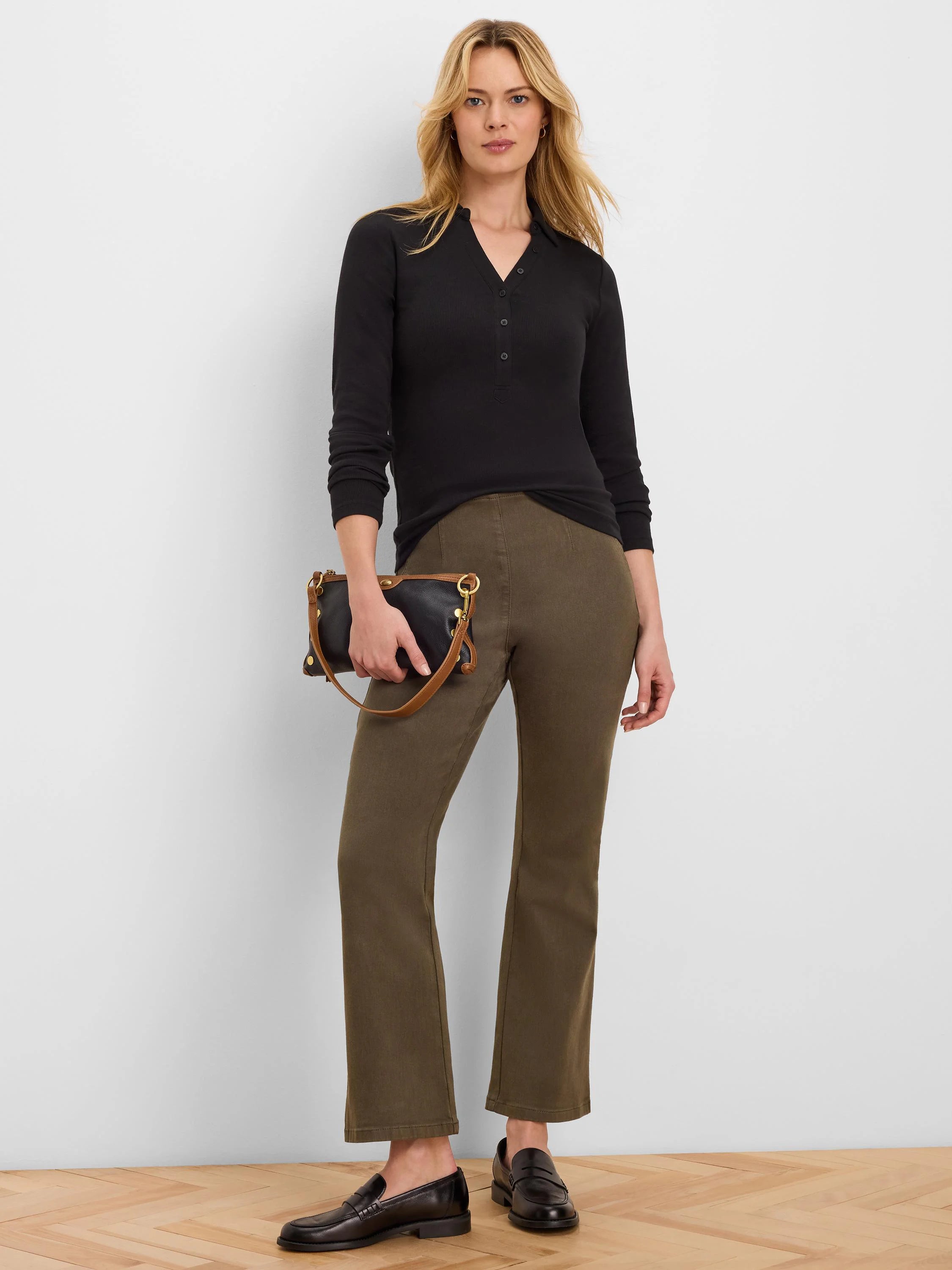 Black ribbed knit long-sleeve polo with collar and button placket.
