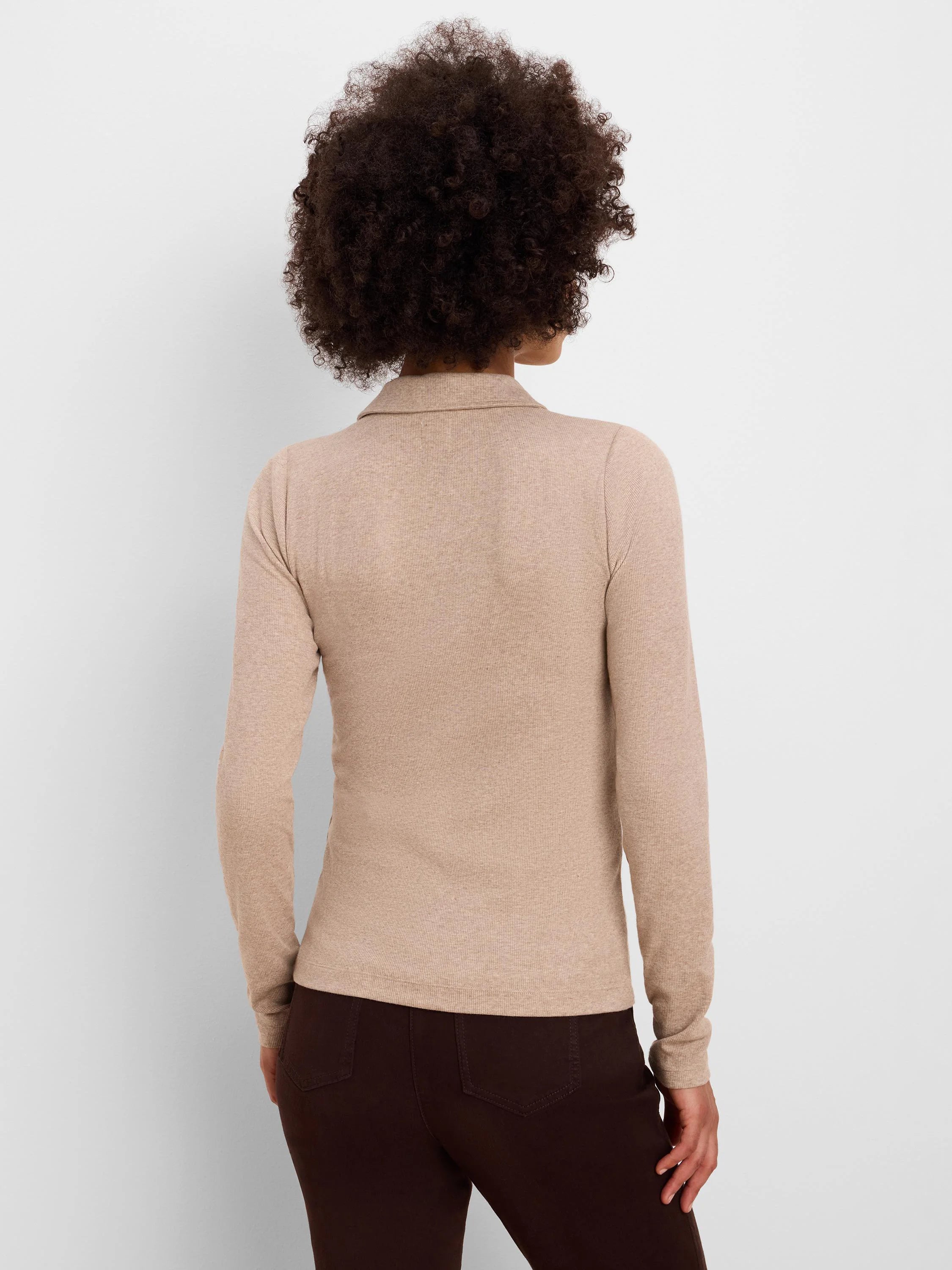 Back view of a person wearing a light beige, ribbed, long-sleeved polo.