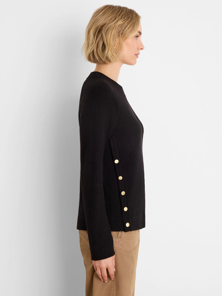 Black waffle top with four gold buttons vertically down the left side.