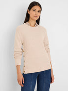 Light beige waffle knit top with long sleeves and gold buttons down the left side.