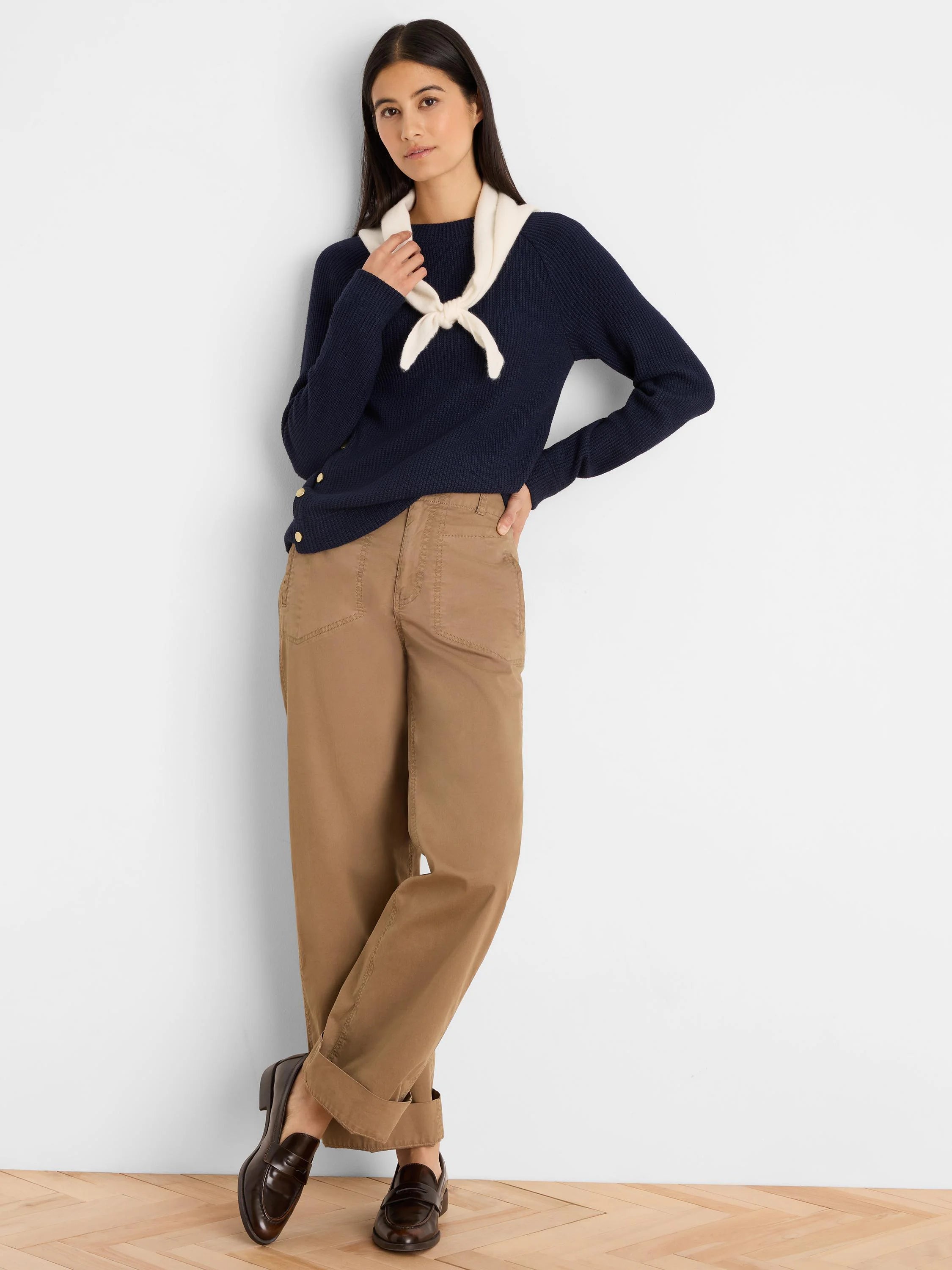Navy blue long-sleeve waffle knit top with gold-toned buttons along the left side.