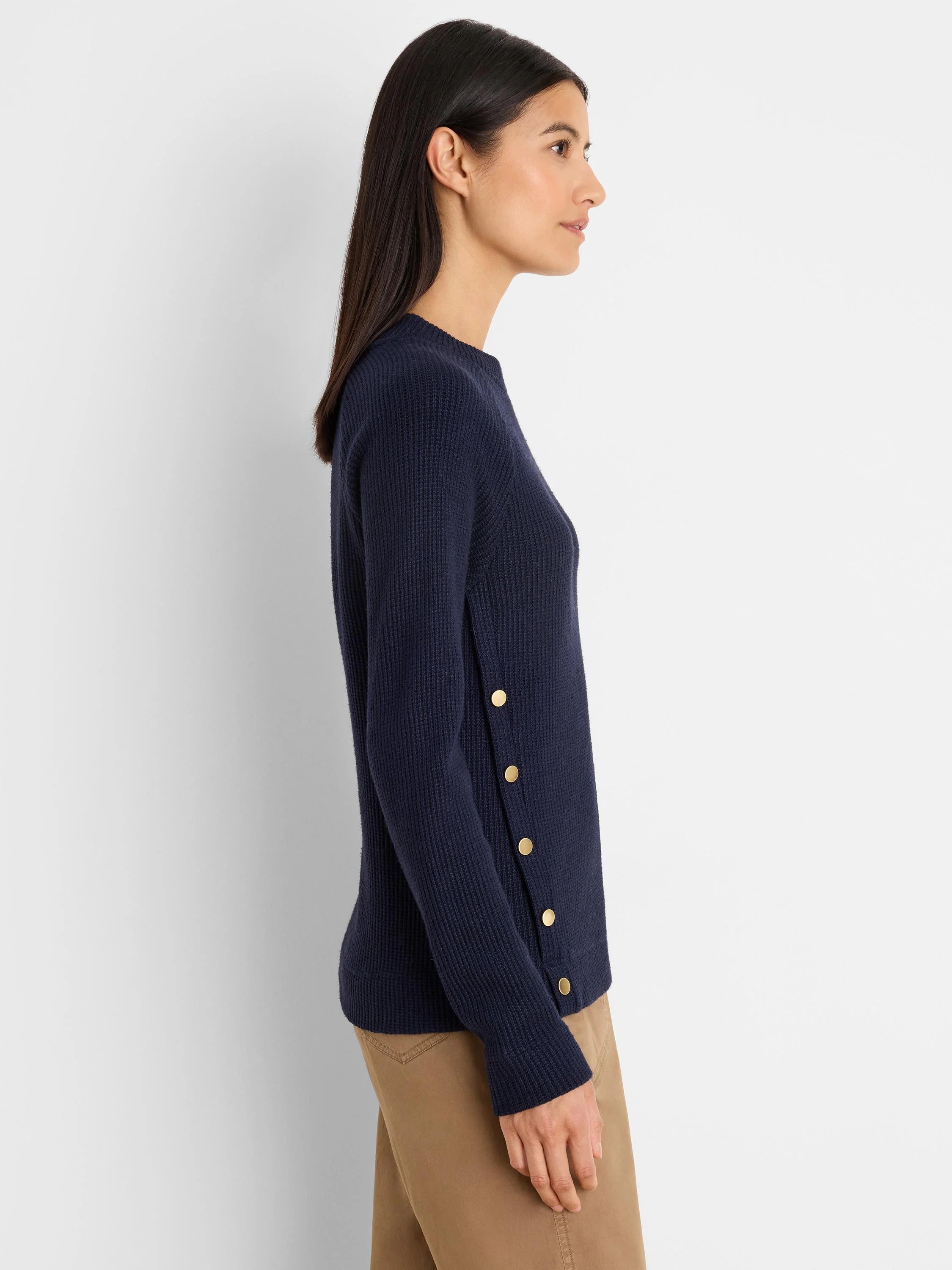 Navy blue long-sleeve waffle knit top with five gold buttons down the left side.