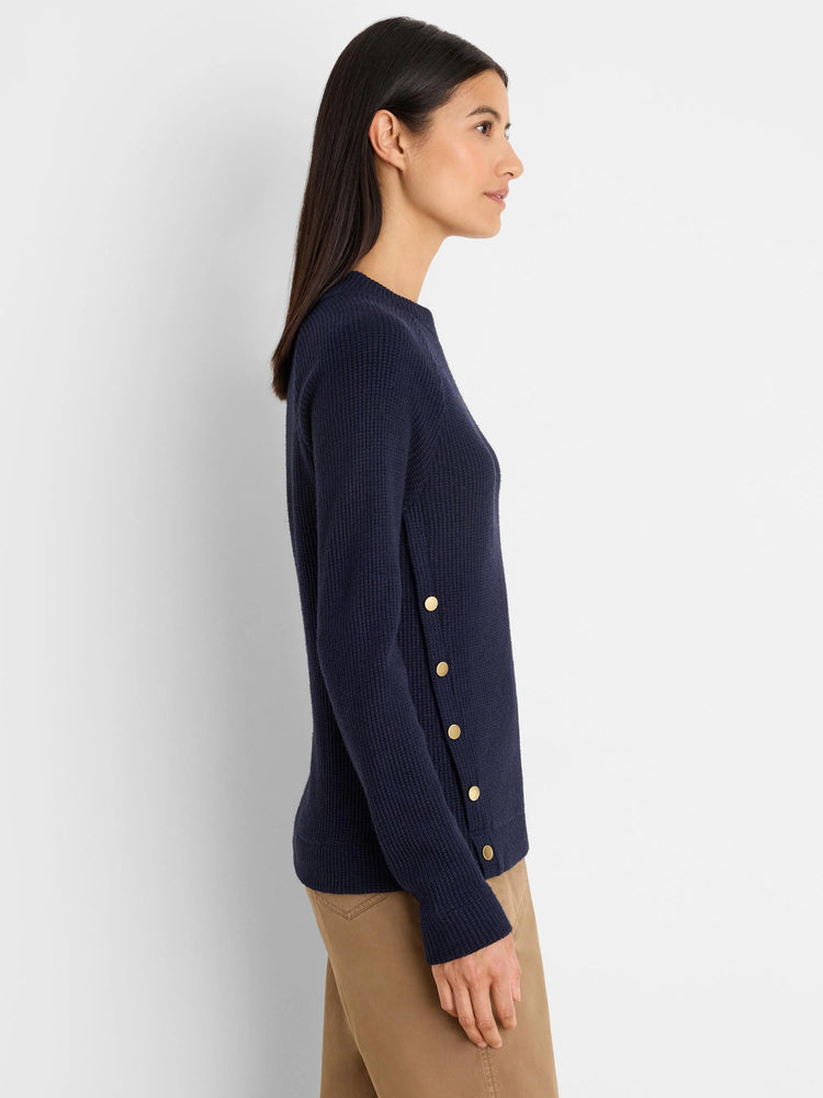 Navy blue long-sleeve waffle knit top with five gold buttons down the left side.