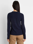 Navy blue waffle knit long-sleeved top with a ribbed crew neck, seen from the back.
