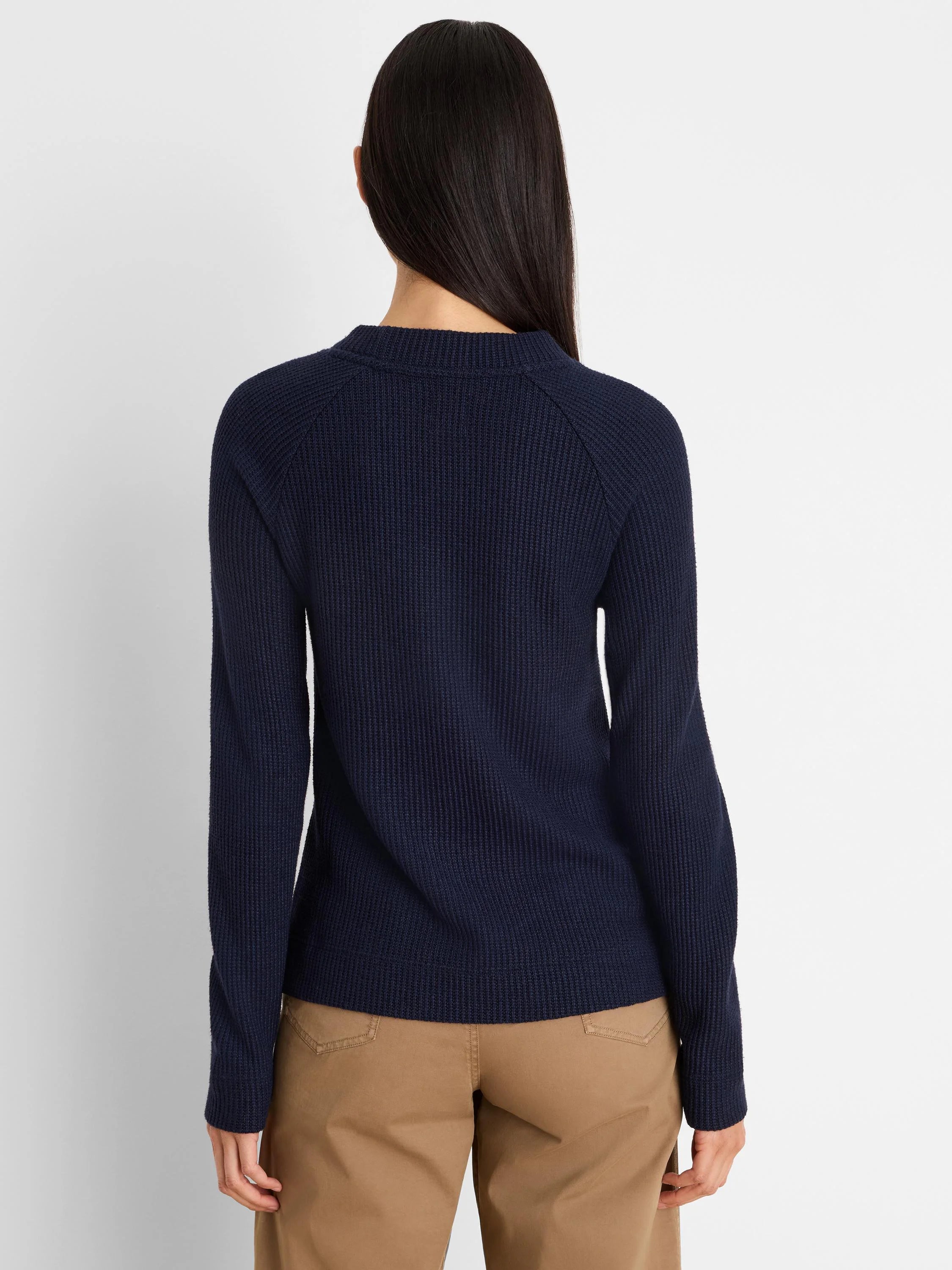 Navy blue waffle knit long-sleeved top with a ribbed crew neck, seen from the back.