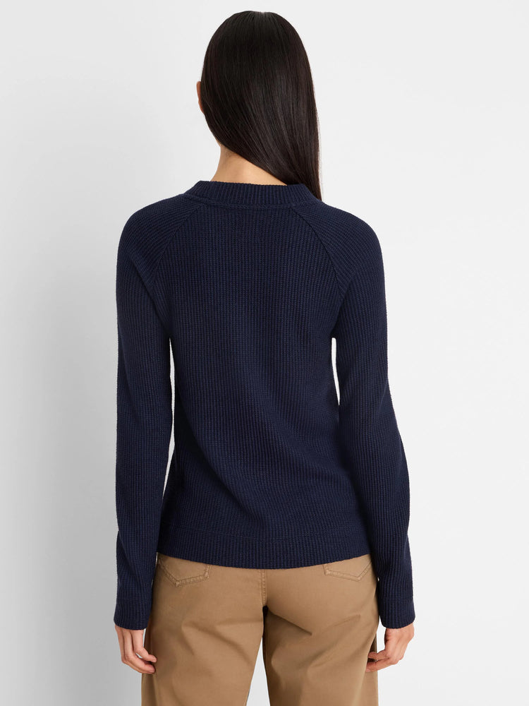Navy blue waffle knit long-sleeved top with a ribbed crew neck, seen from the back.