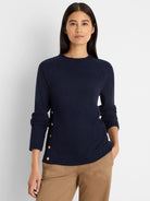 Navy waffle knit top with gold buttons down the left side. Features a crew neck and long sleeves.