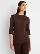Dark brown waffle knit top with a crew neck, raglan sleeves, and gold buttons lining the left side.