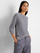 Light grey waffle knit top with a crew neck, long sleeves, and gold buttons along the left side.