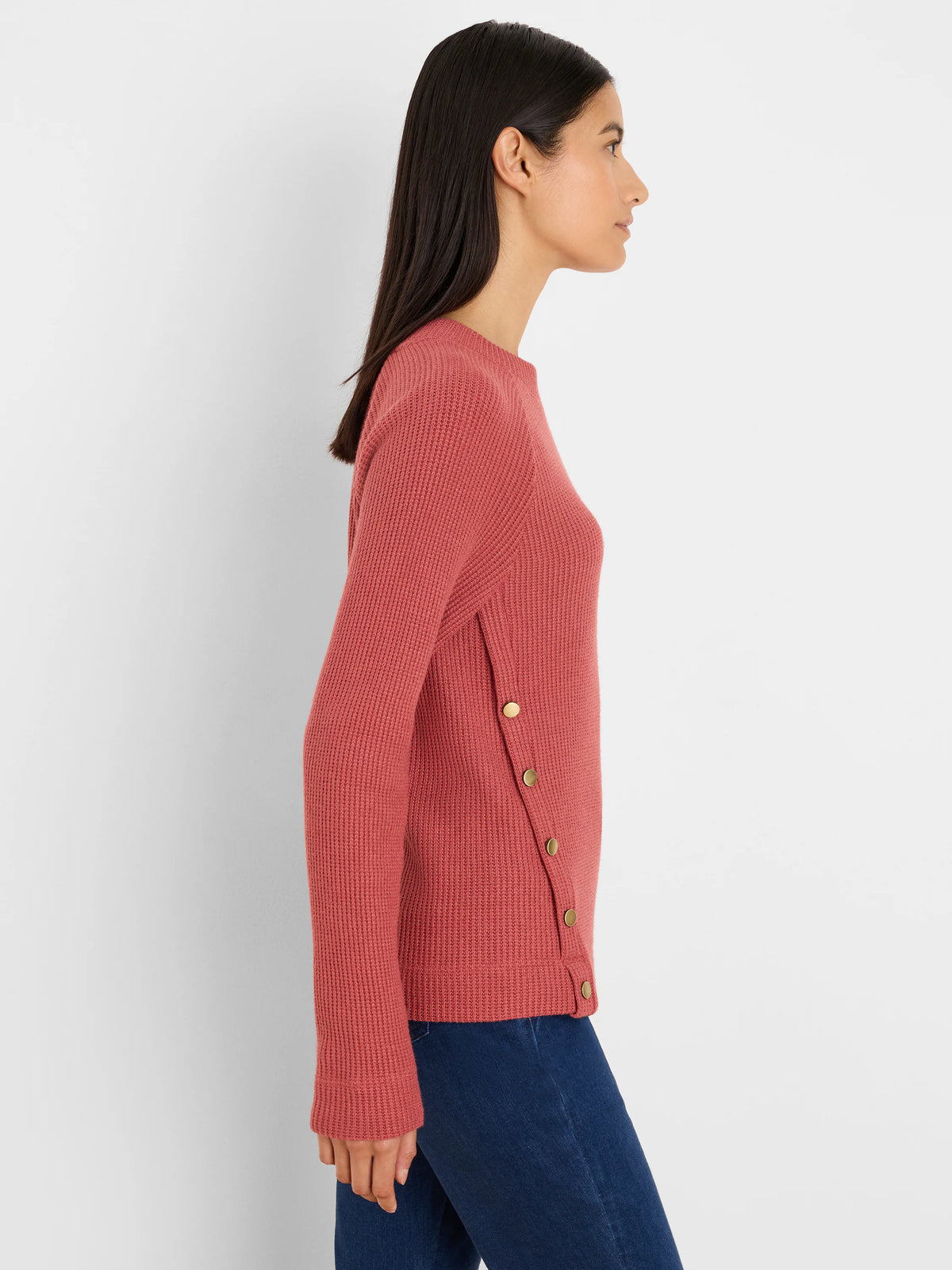 Rose pink waffle knit top with long sleeves, crew neck, and gold buttons down the left side.