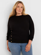 Black waffle knit top with gold buttons along the left side. Features a crew neck and long sleeves.
