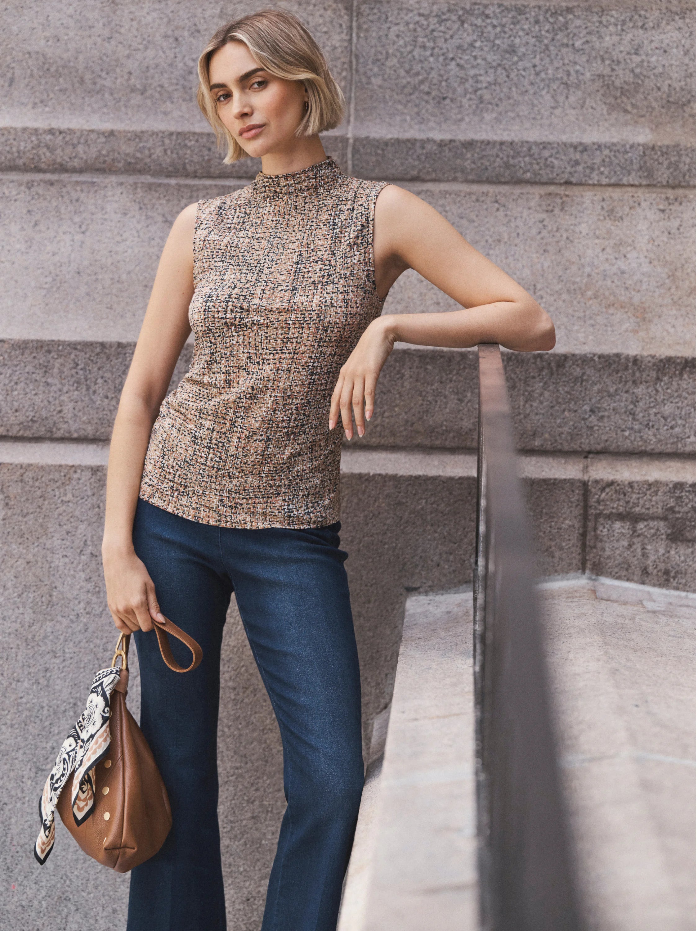 Sleeveless mock neck tank in a tan, brown, and black tweed knit.