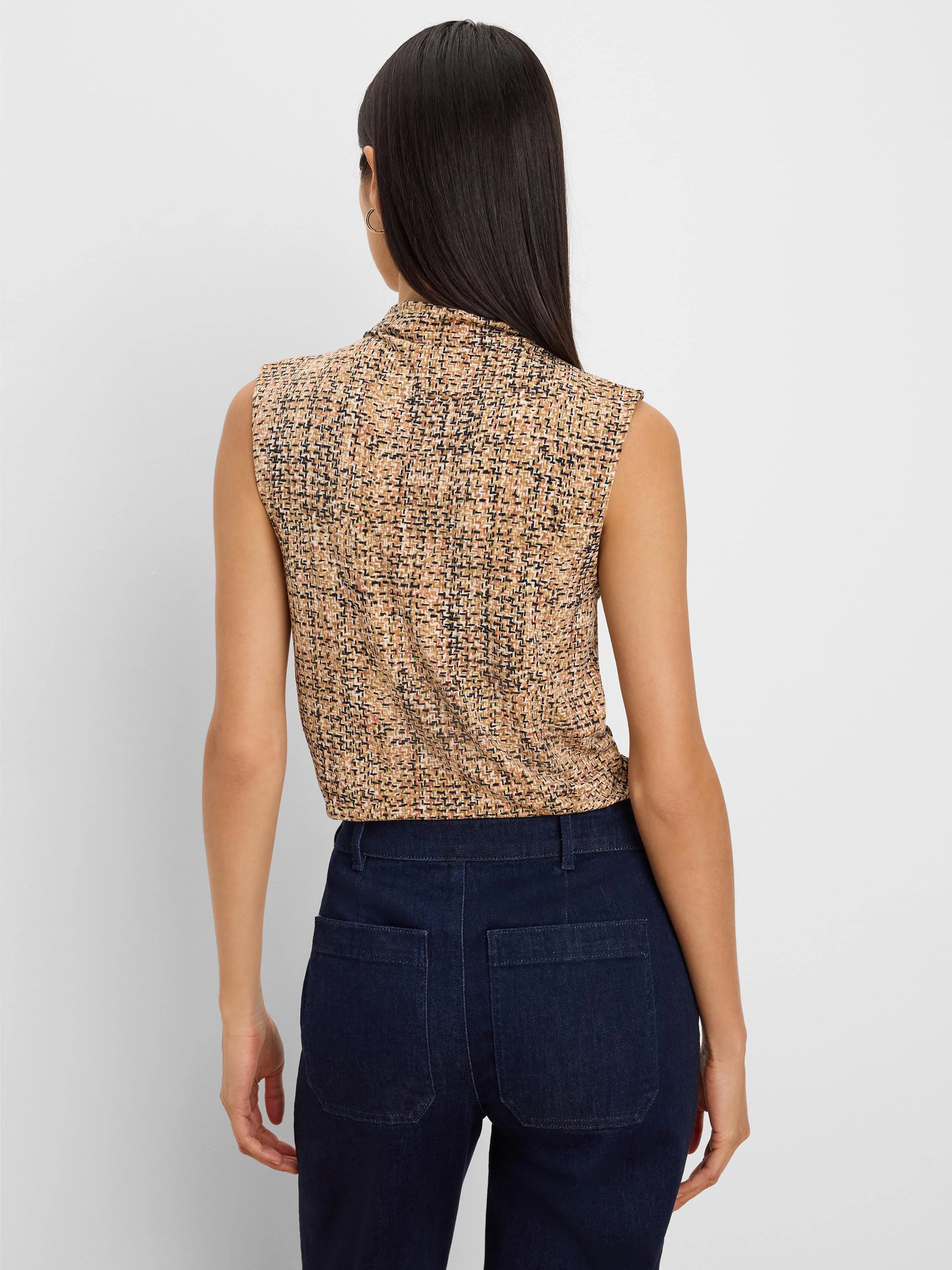 Sleeveless, mock-neck tank with a tan, black, and pink-brown tweed print, worn by a model from the back.