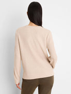 Light beige long-sleeve waffle knit top, shown from the back on a model. Features a crew neck and ribbed cuffs.