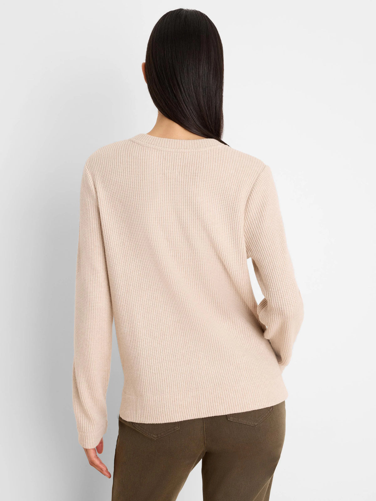 Light beige long-sleeve waffle knit top, shown from the back on a model. Features a crew neck and ribbed cuffs.