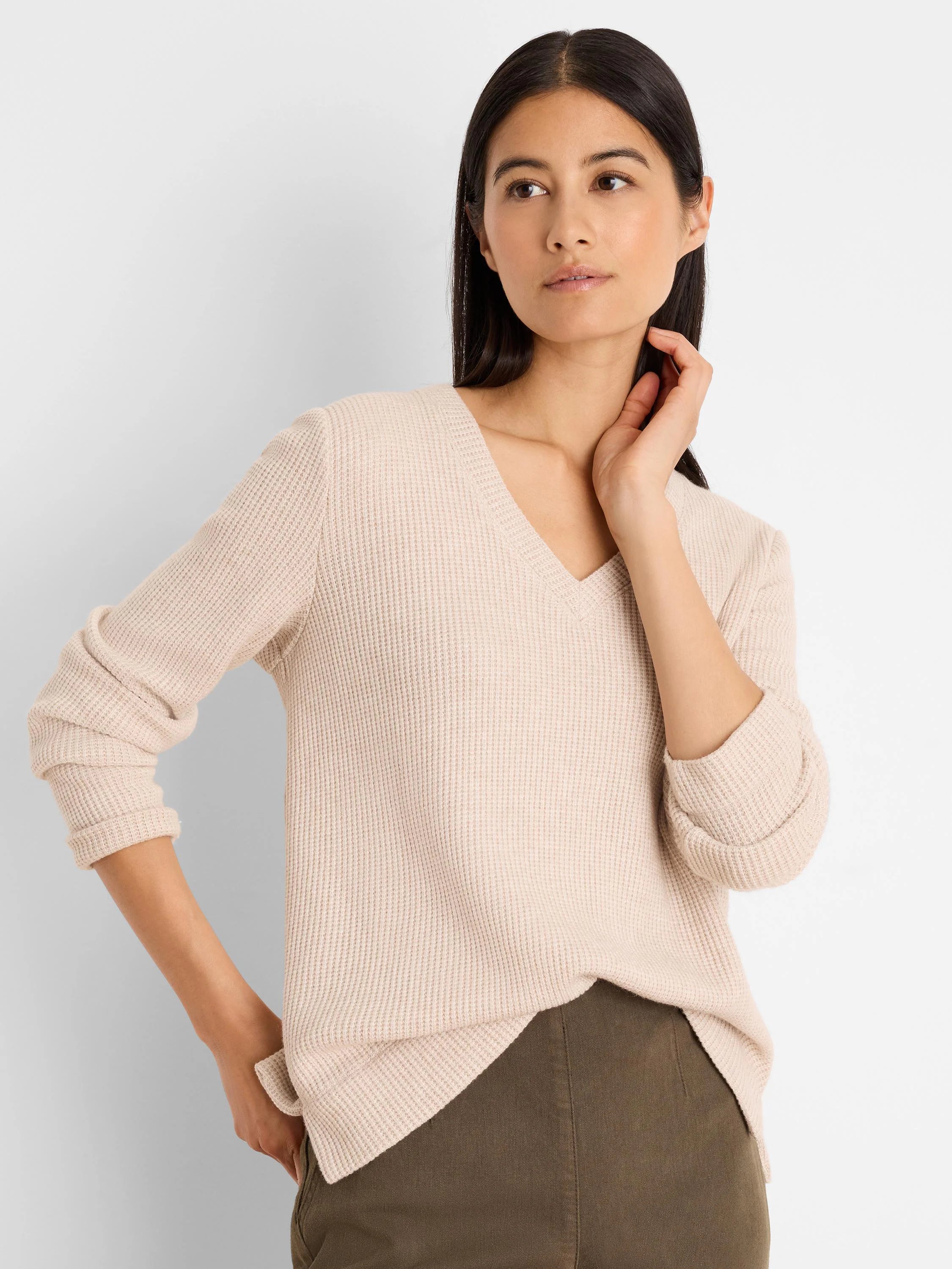 Pale beige waffle knit thermal top with a V-neck and long sleeves.