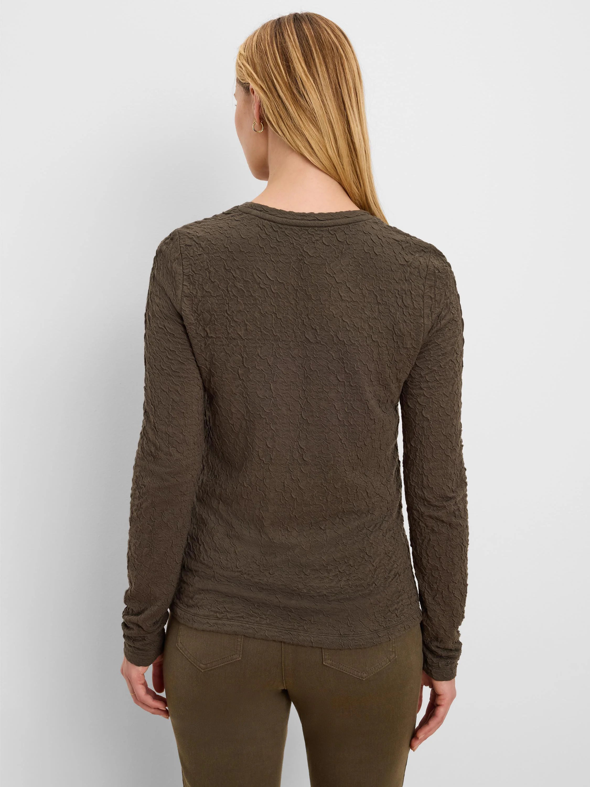 Dark moss green long-sleeve top with all-over crinkle knit texture.
