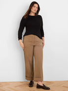 Black long-sleeved top with subtle crinkle knit texture, worn by a model.
