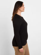 Black crinkle knit textured long-sleeve top.