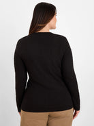 Black crinkle knit long-sleeve top with visible all-over texture, shown from the back on a model.