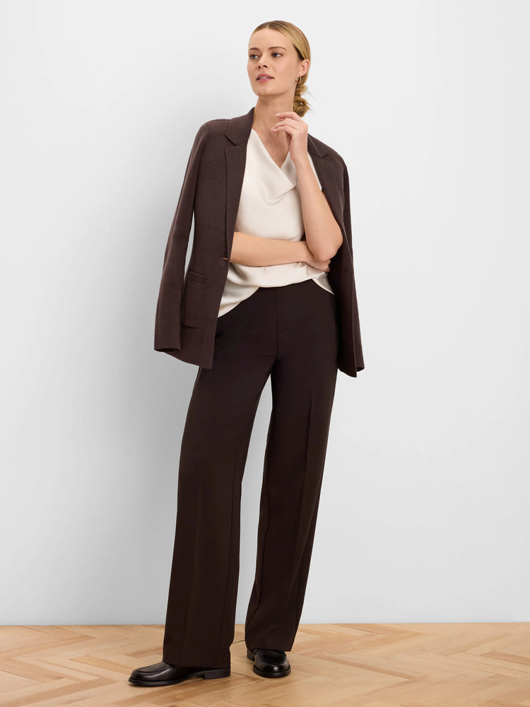 Dark brown knit blazer. Relaxed fit, soft texture, with front patch pockets. Draped over shoulders.