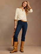 Ecru Henley sweater with a tan inner placket and ruffled collar/cuffs.