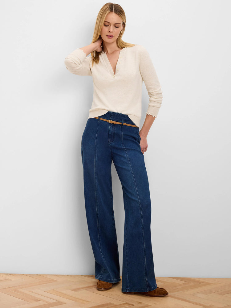 Cream henley sweater with V-neck button placket, ruffled trim on neckline and cuffs.