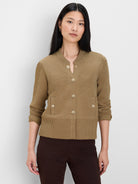 Tan knit bomber jacket with gold snap closure, two snap patch pockets, ribbed collar & hem.